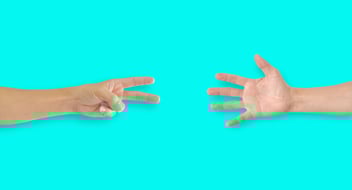 two hands playing rock, paper, scissors 