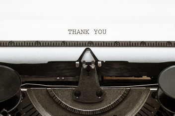 Thank you note being typed on a typewriter
