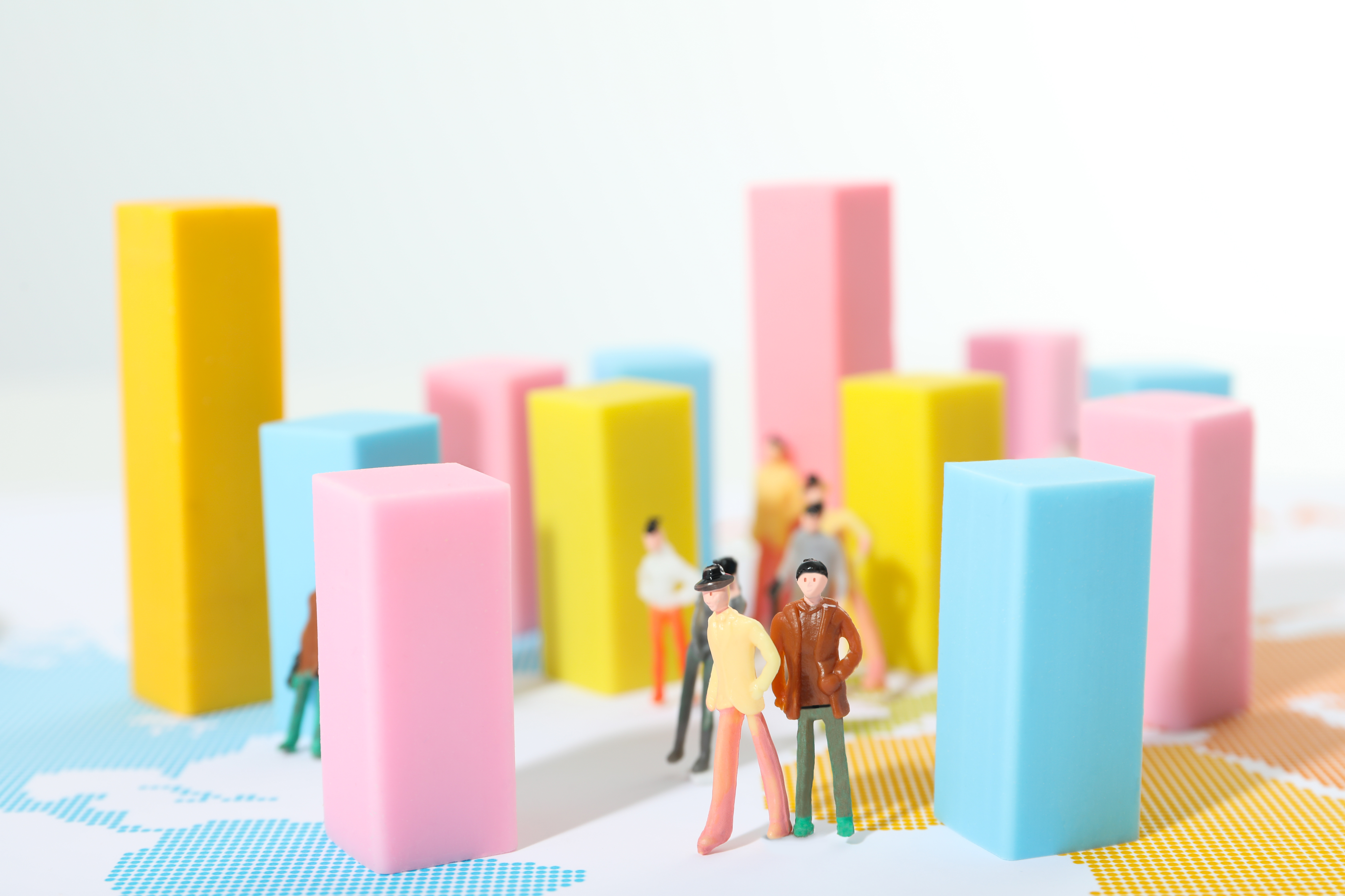 small figurines walking around a data chart